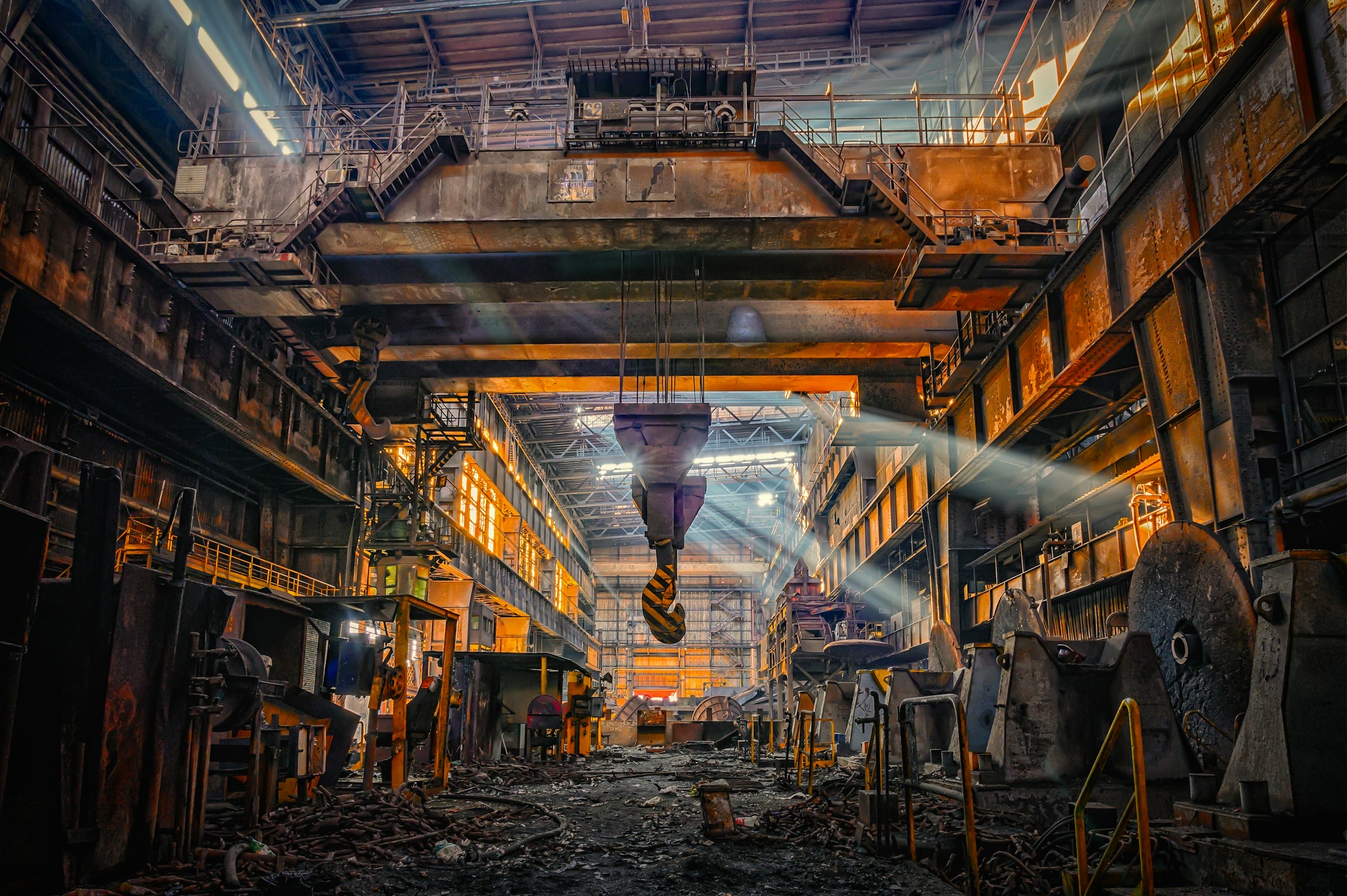 Steel mill interior with molten metal and sparks at night